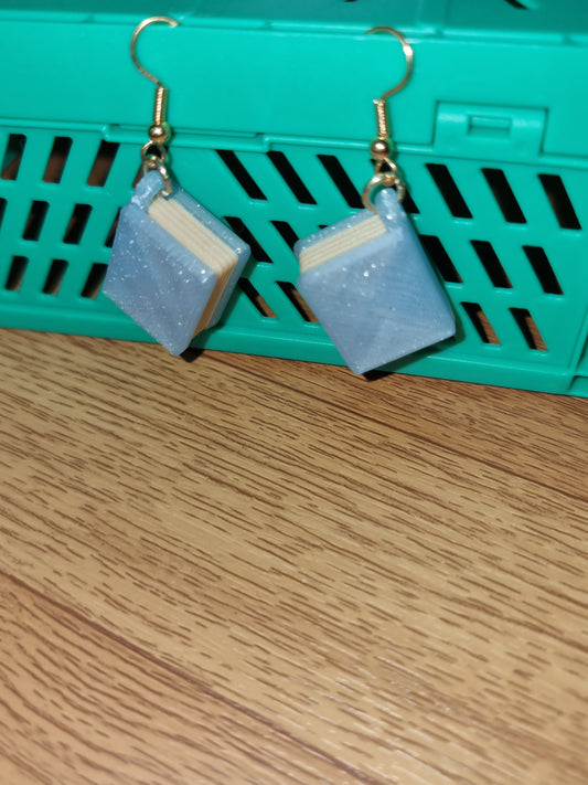 Pair of unique 3D printed book earrings with intricate details, perfect for book lovers.