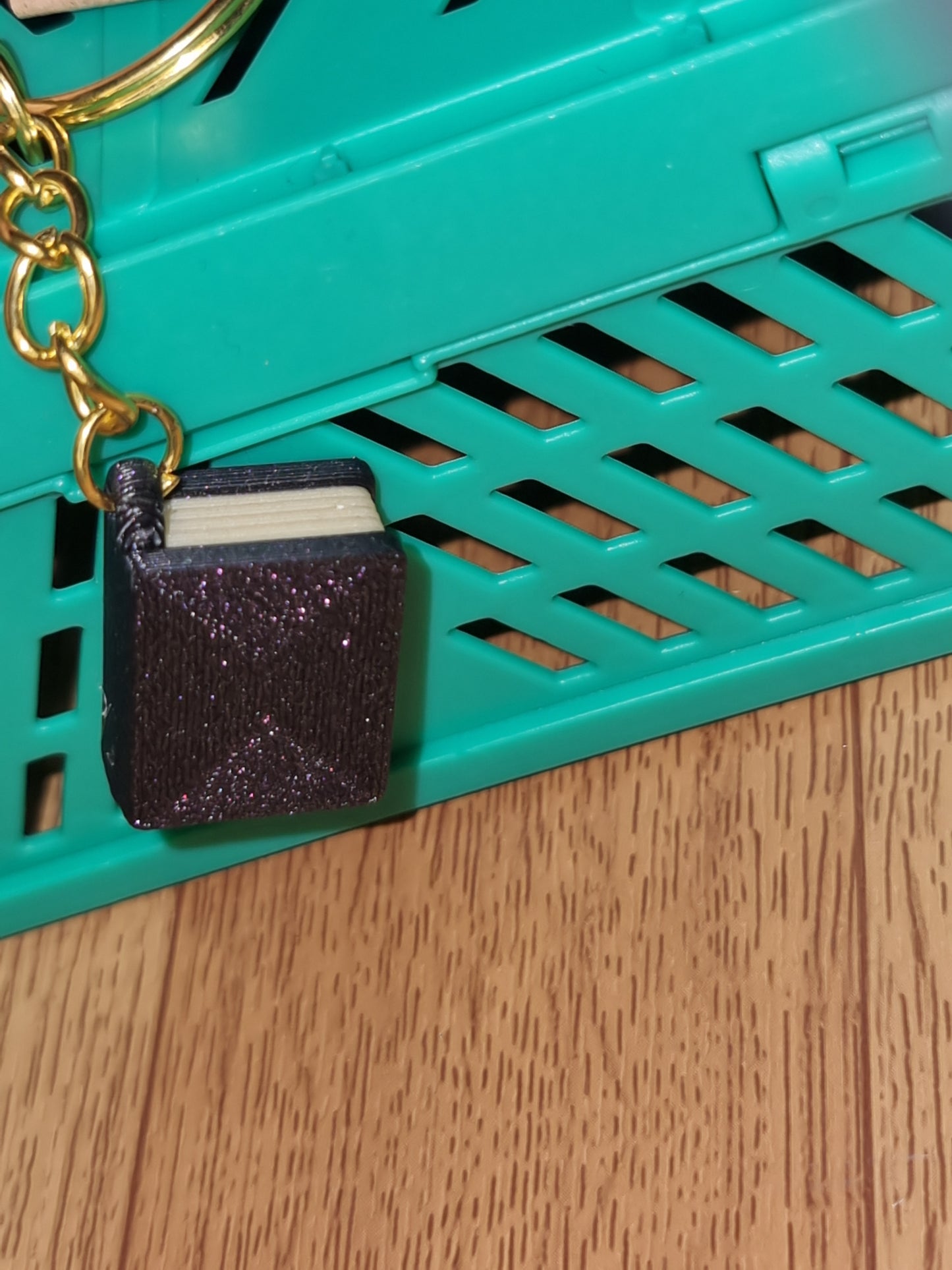 A unique 3D printed book keyrings with intricate details, perfect for book lovers.