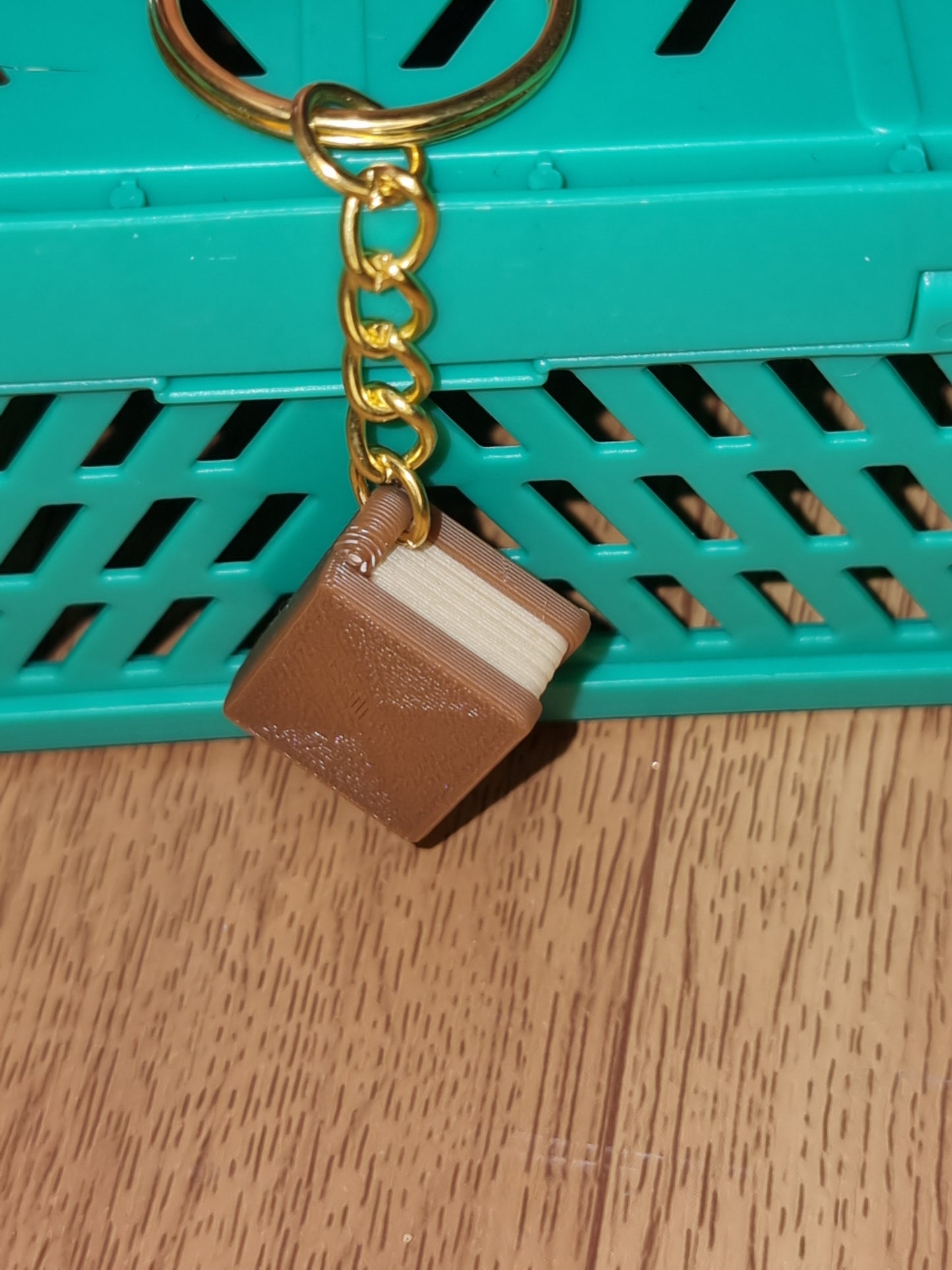 A unique 3D printed book keyrings with intricate details, perfect for book lovers.