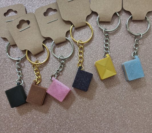 A unique 3D printed book keyrings with intricate details, perfect for book lovers.
