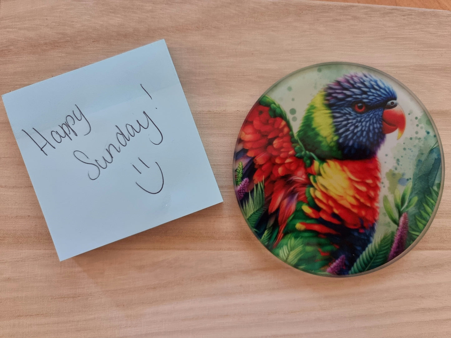 Round glass coaster with a detailed, colorful Lorikeet sublimation print, protecting surfaces in style.