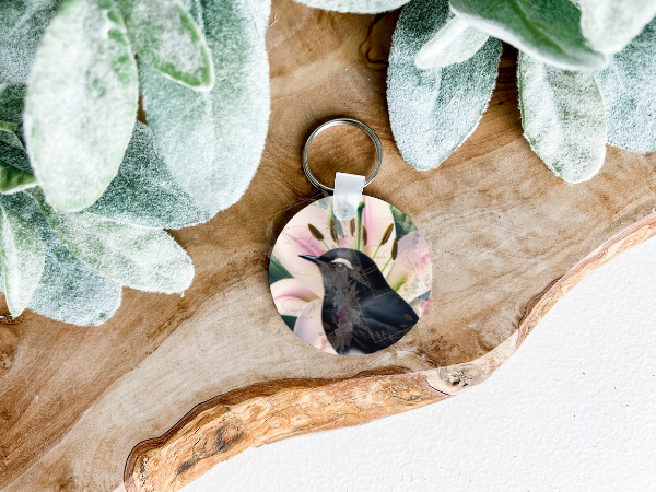 Lightweight double-sided MDF keyring featuring a Willie Wagtail with a pink lily on both sides, a charming personal accessory