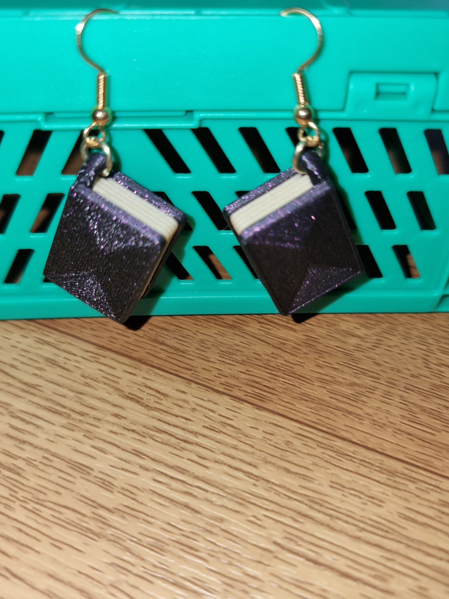 Pair of unique 3D printed book earrings with intricate details, perfect for book lovers.