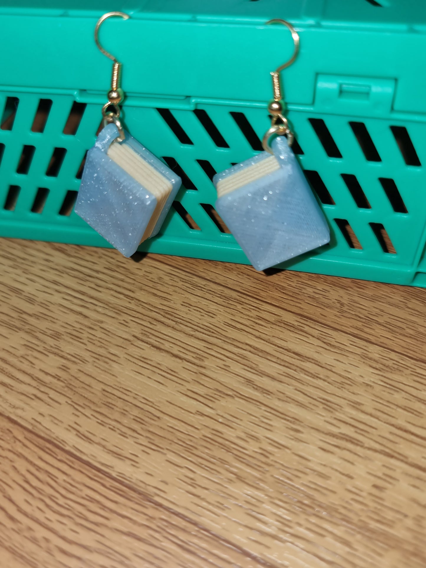 Pair of unique 3D printed book earrings with intricate details, perfect for book lovers.