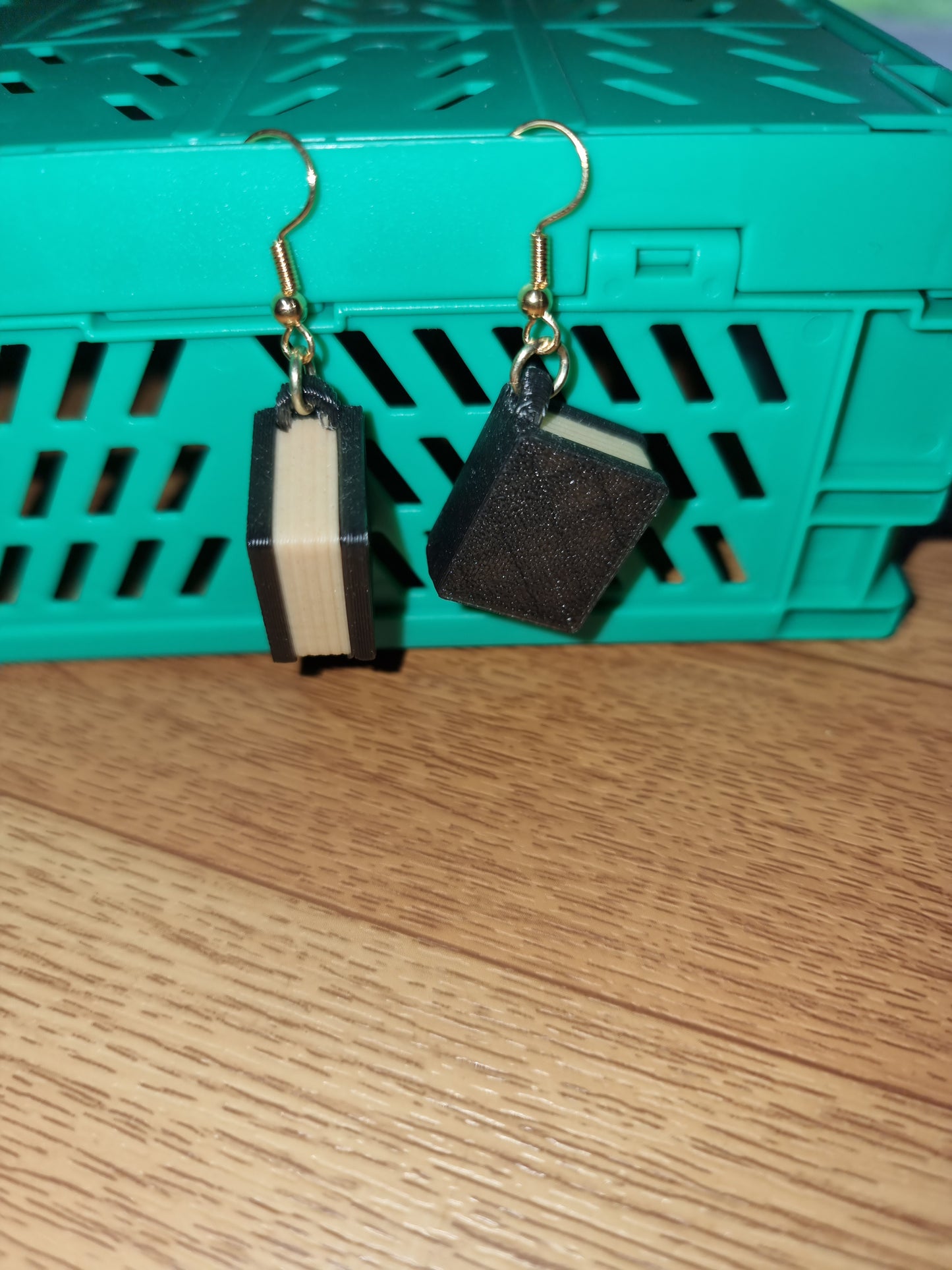 Pair of unique 3D printed book earrings with intricate details, perfect for book lovers.