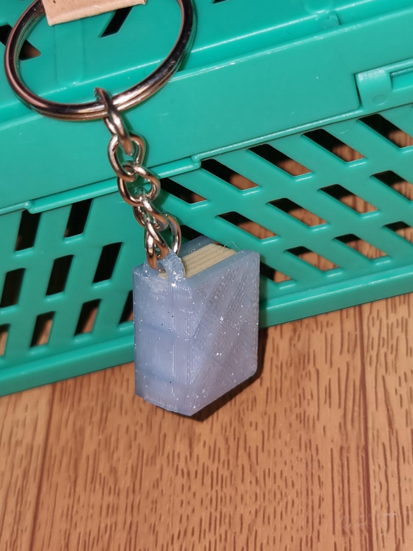 A unique 3D printed book keyrings with intricate details, perfect for book lovers.