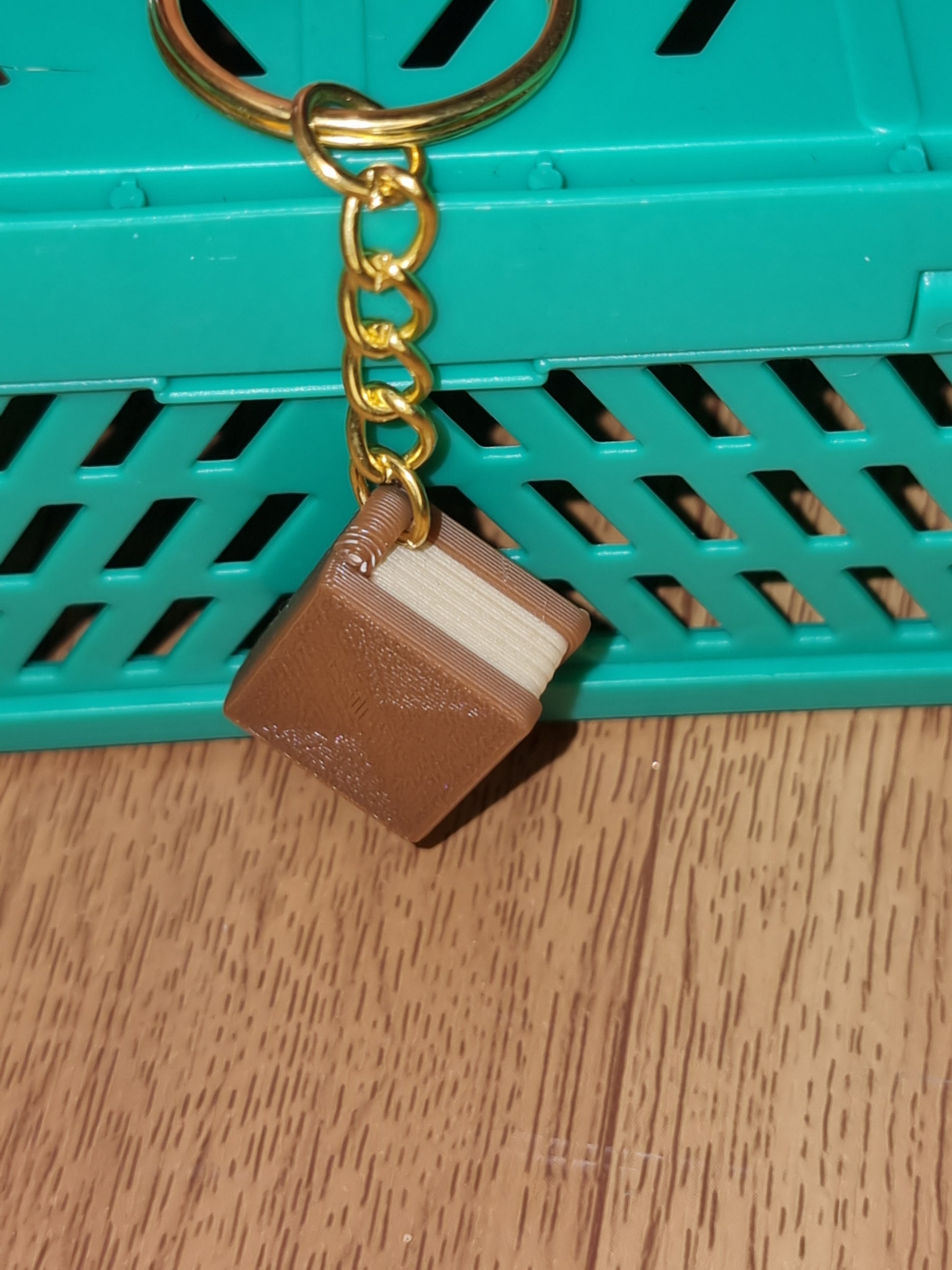 A unique 3D printed book keyrings with intricate details, perfect for book lovers.