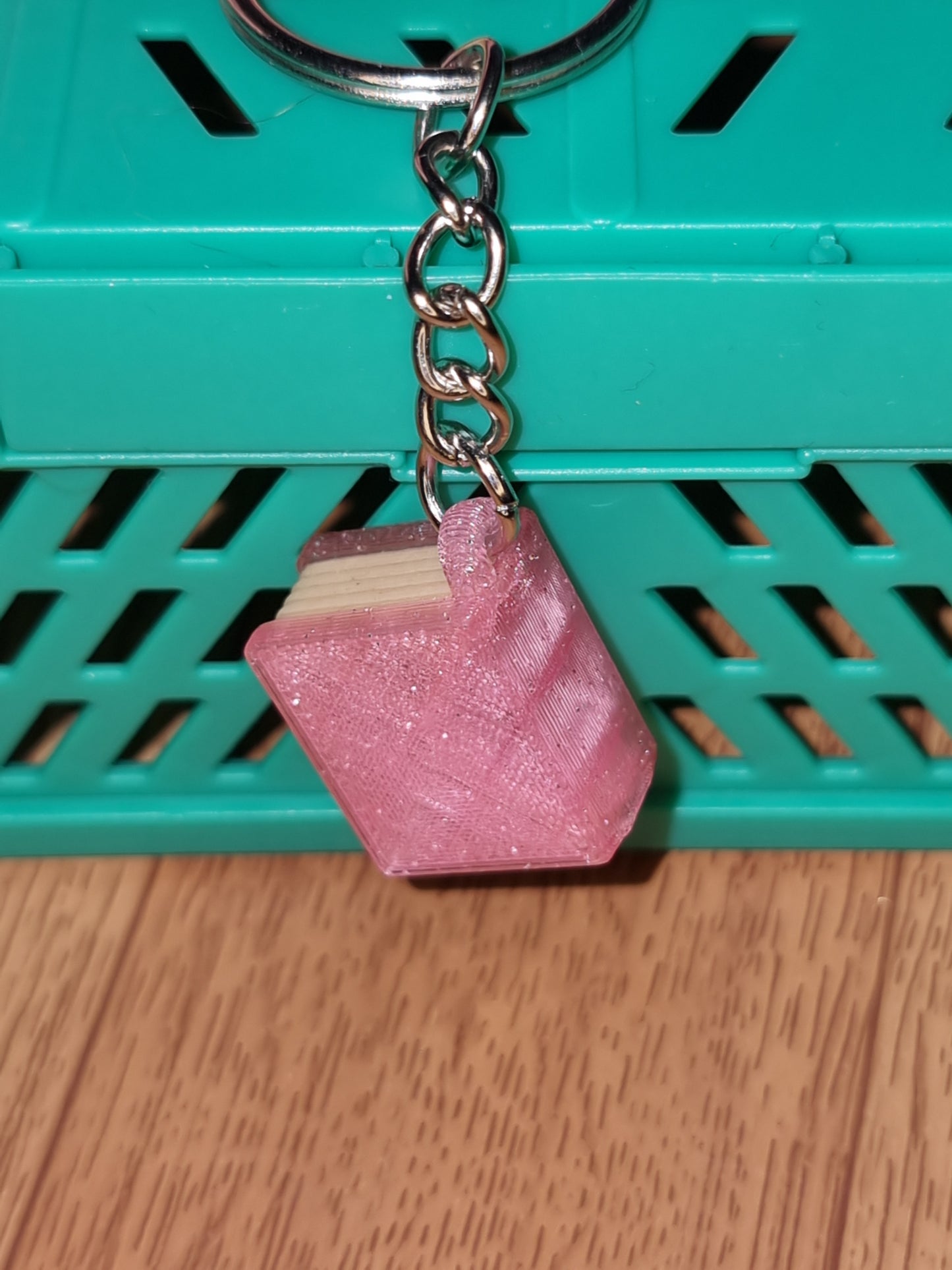 A unique 3D printed book keyrings with intricate details, perfect for book lovers.