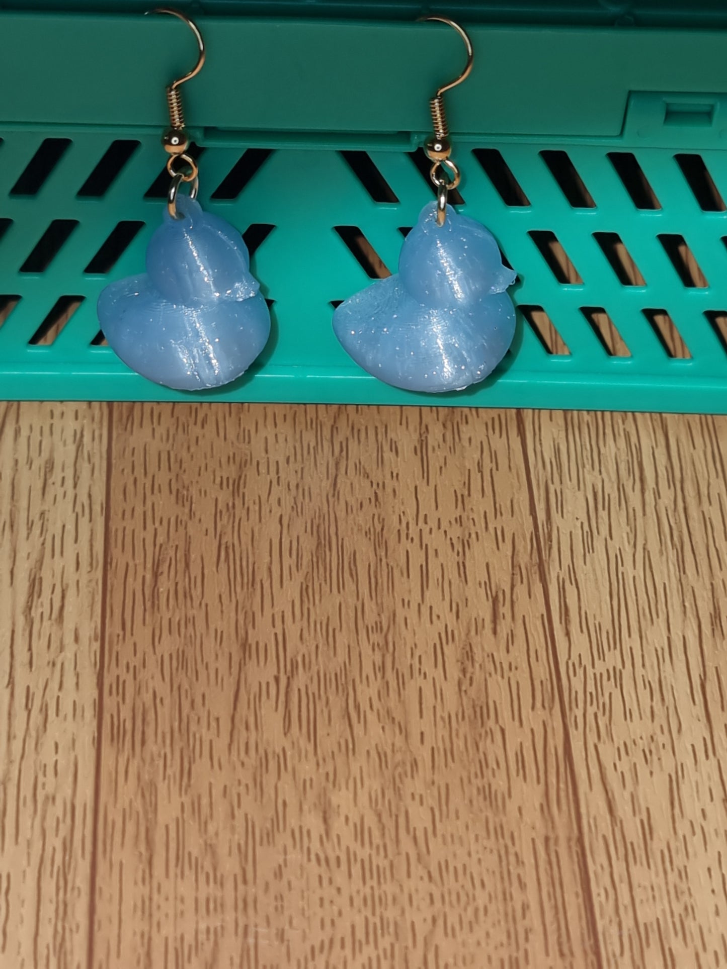 Pair of unique 3D printed duck earrings with intricate details, perfect for adding a whimsical touch.