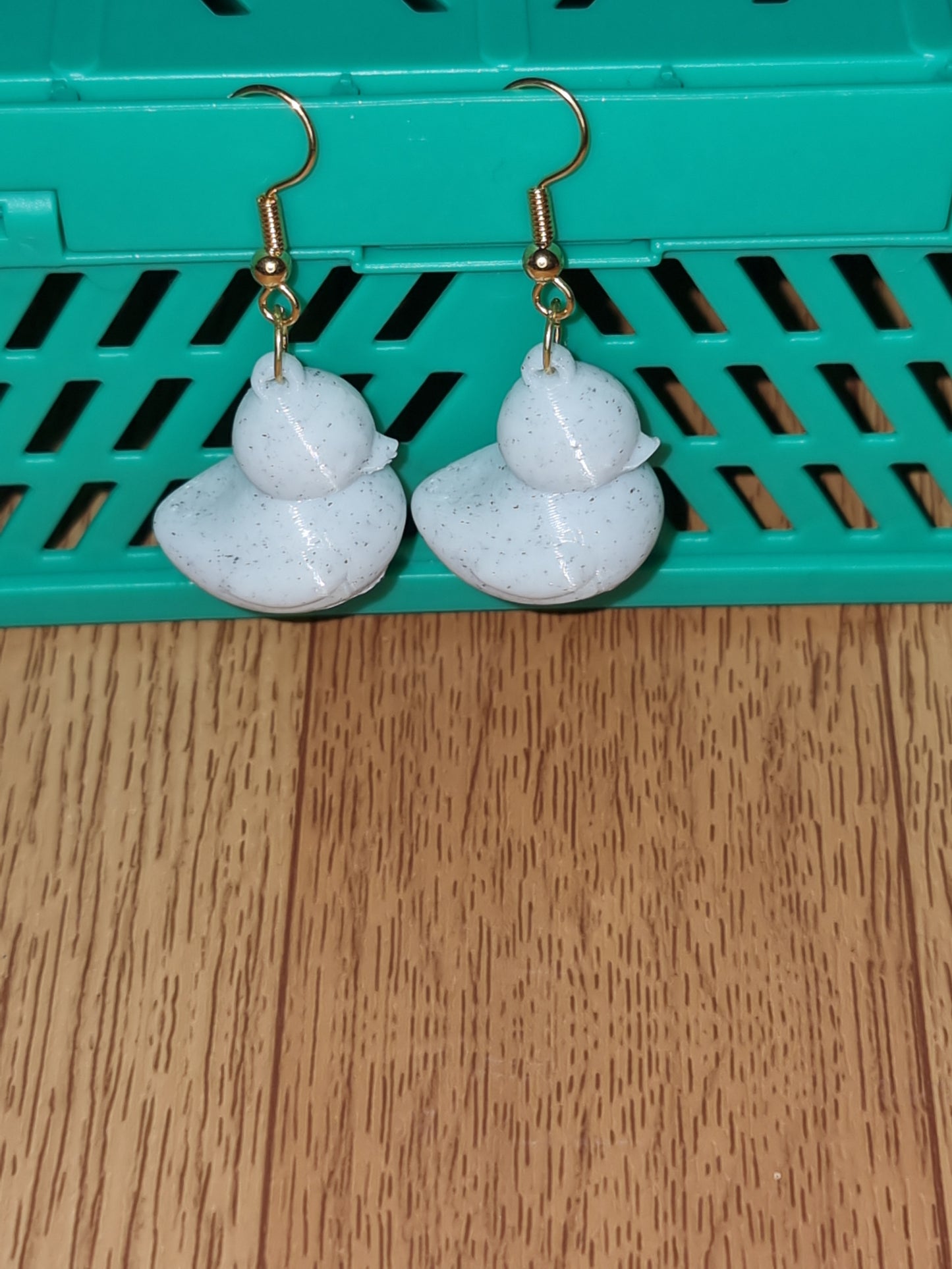 Pair of unique 3D printed duck earrings with intricate details, perfect for adding a whimsical touch.