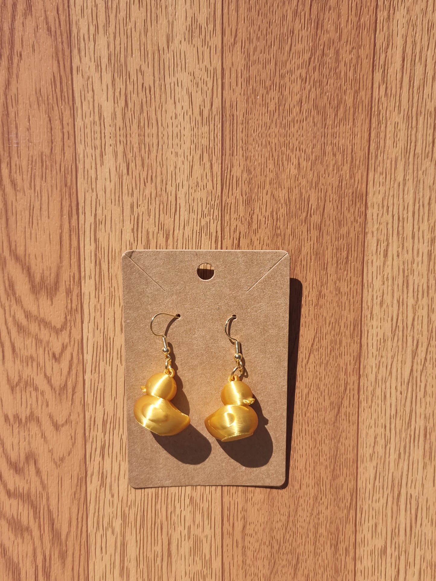 Pair of unique 3D printed duck earrings with intricate details, perfect for adding a whimsical touch.