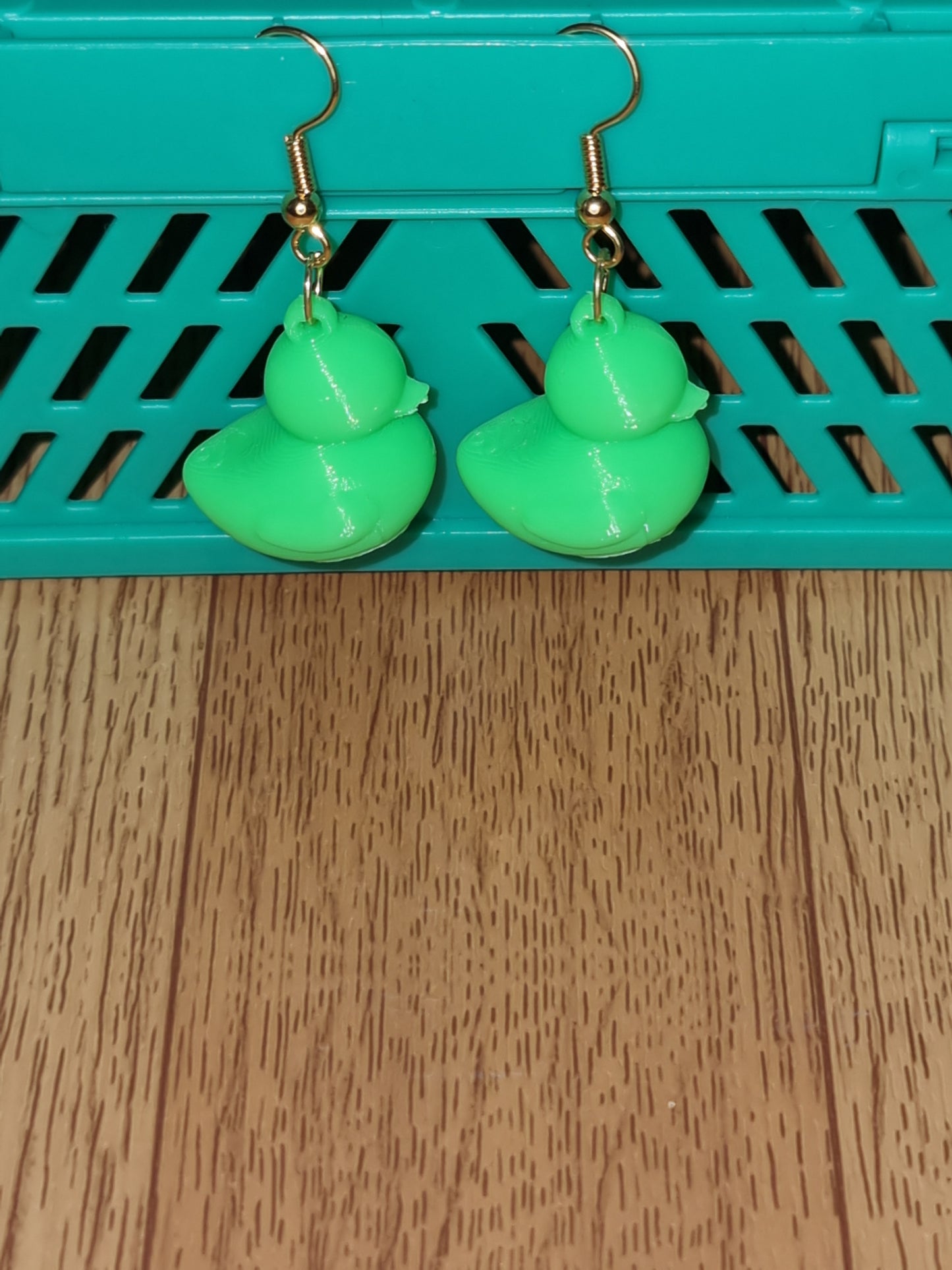 Pair of unique 3D printed duck earrings with intricate details, perfect for adding a whimsical touch.