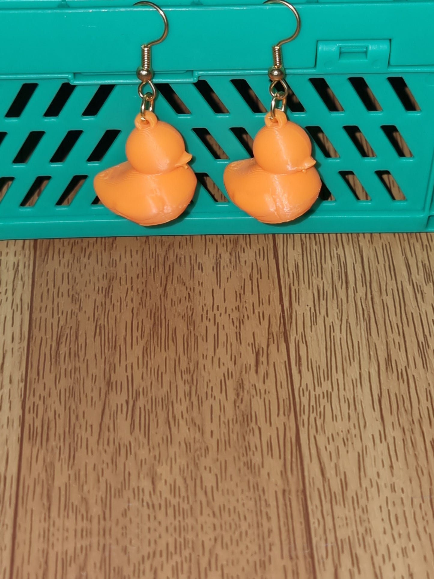 Pair of unique 3D printed duck earrings with intricate details, perfect for adding a whimsical touch.