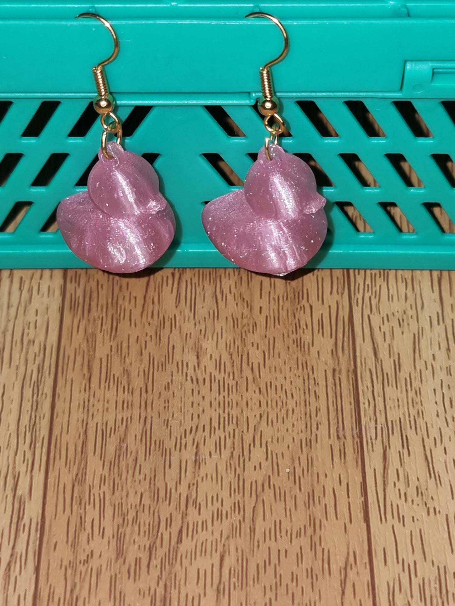 Pair of unique 3D printed duck earrings with intricate details, perfect for adding a whimsical touch.