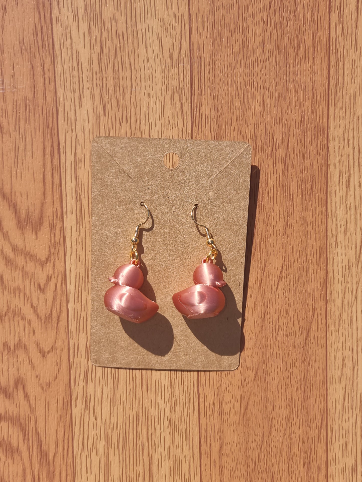 Pair of unique 3D printed duck earrings with intricate details, perfect for adding a whimsical touch.