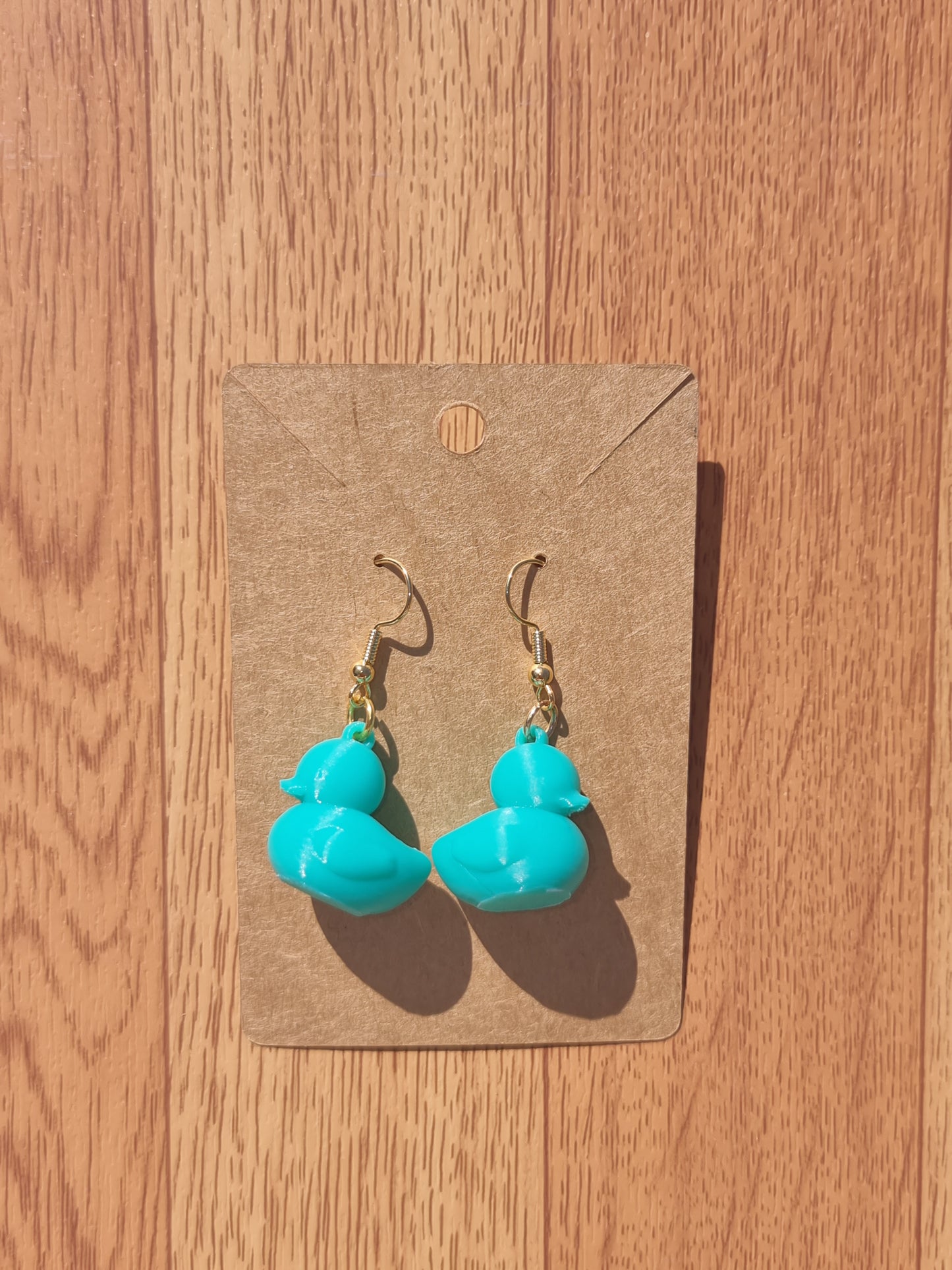 Pair of unique 3D printed duck earrings with intricate details, perfect for adding a whimsical touch.