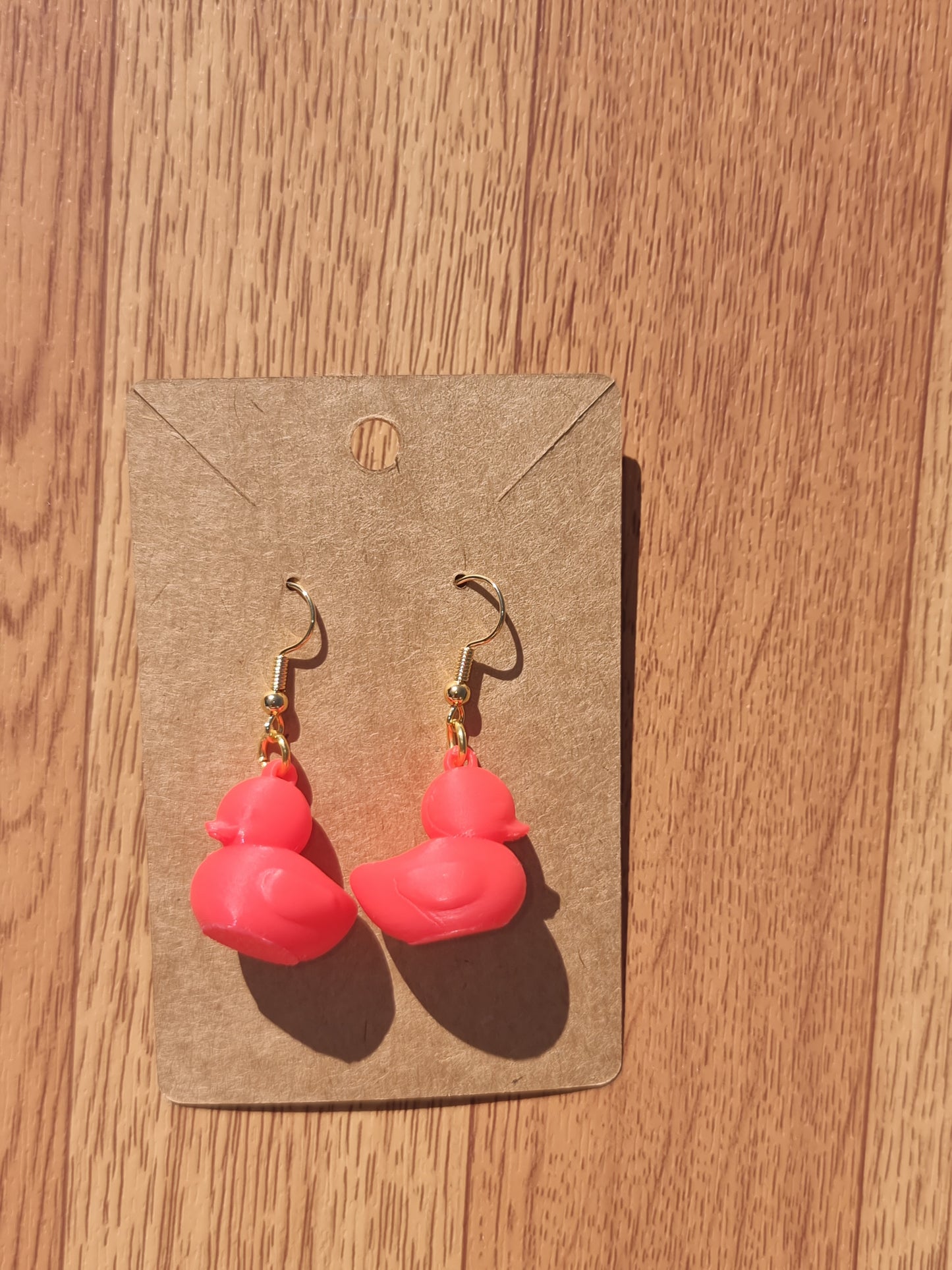 Pair of unique 3D printed duck earrings with intricate details, perfect for adding a whimsical touch.