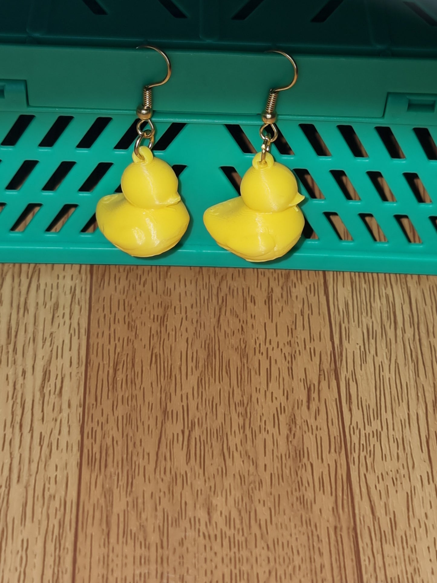 Pair of unique 3D printed duck earrings with intricate details, perfect for adding a whimsical touch.