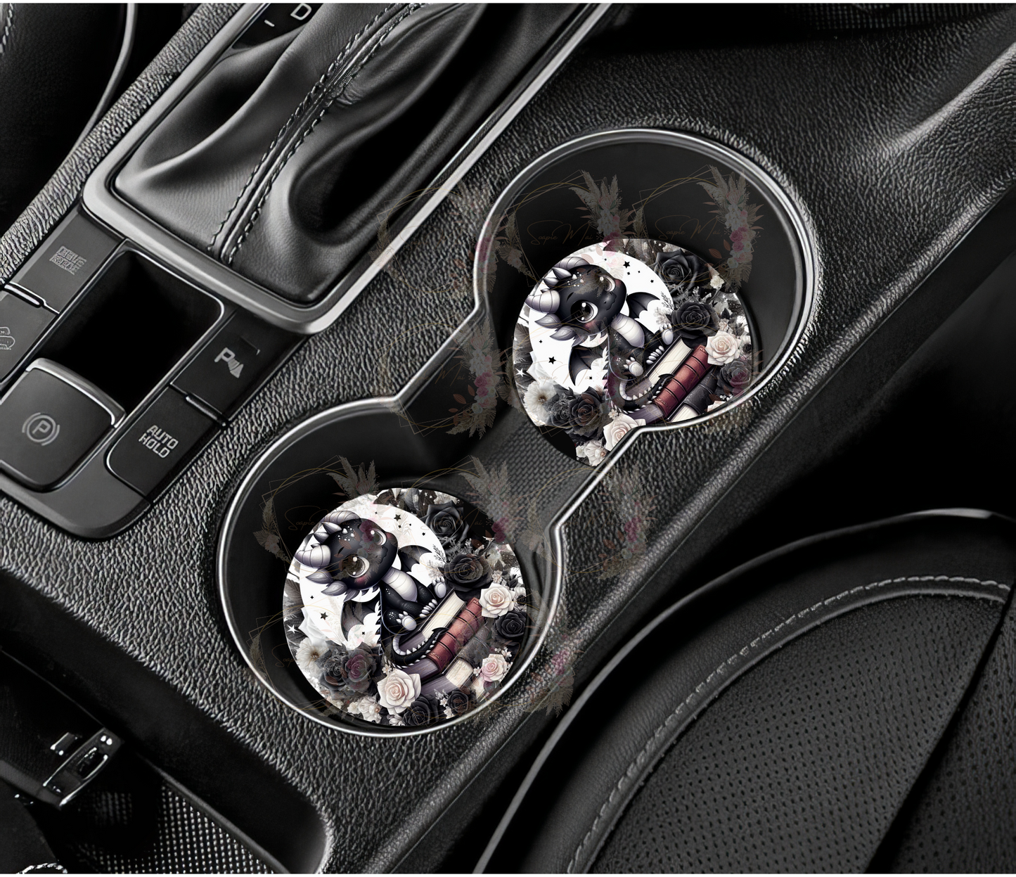 Pair of absorbent car coasters featuring a beautiful black and white design of a dragon on a stack of books with a moon and flowers in the background, protecting your vehicle's cup holders.