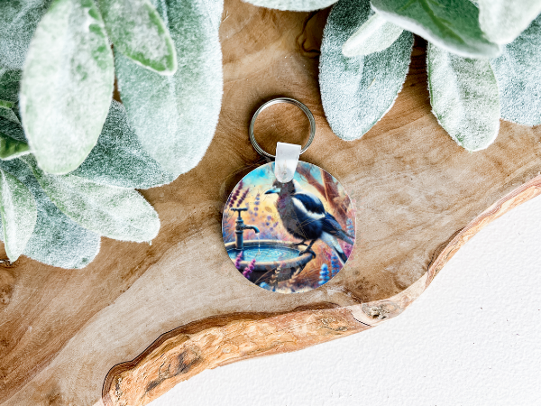 Lightweight double-sided MDF keyring featuring an Australian Magpie on a birdbath on both sides, a charming personal accessory.